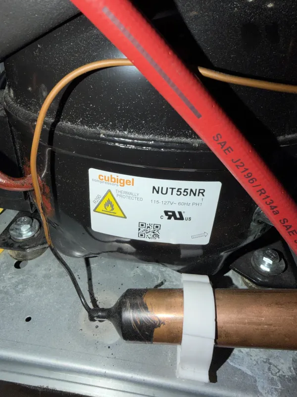Refrigerator compressor connected to service equipment for sealed-system testing
