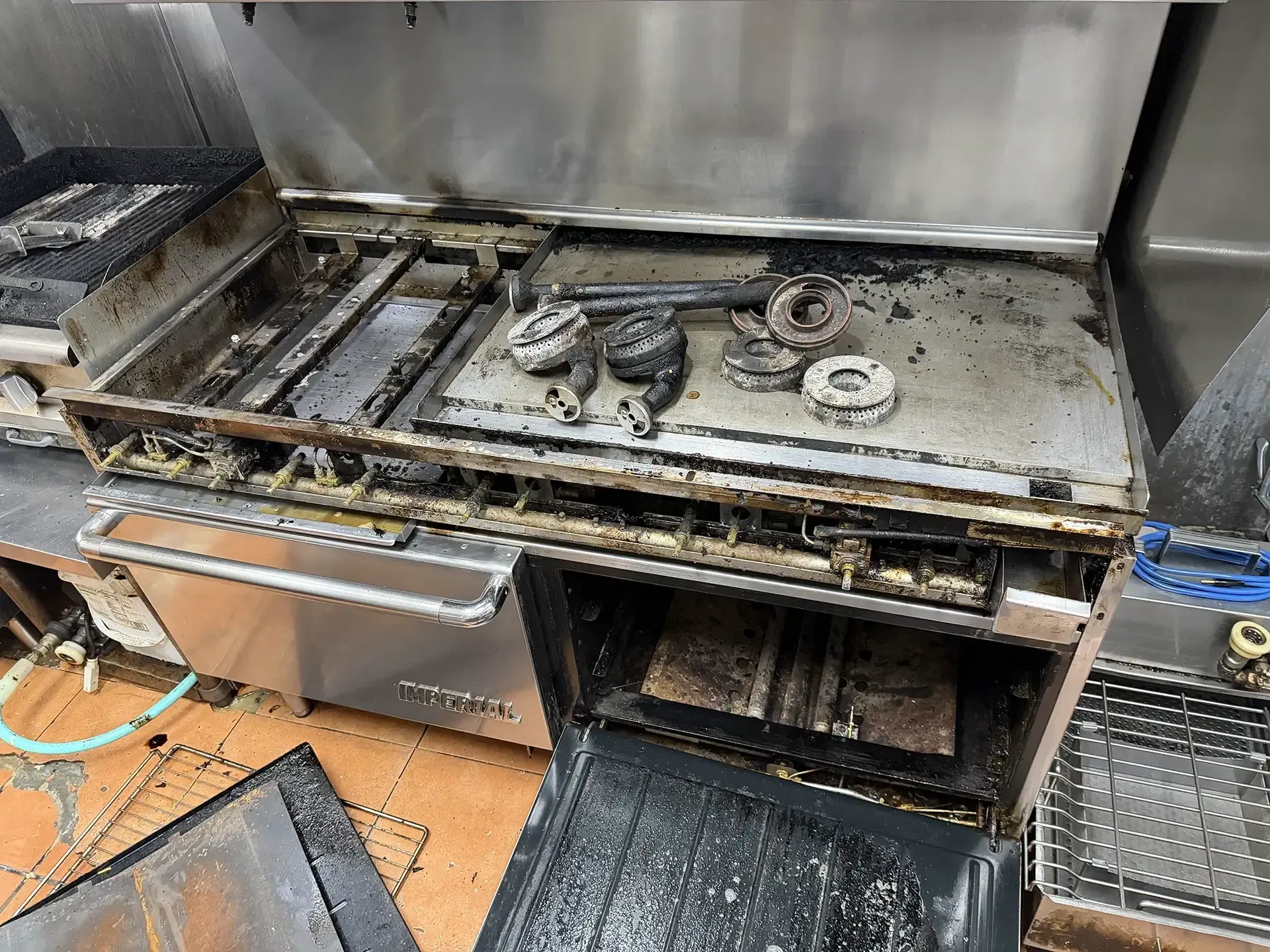 Commercial gas stove & range under repair in commercial kitchen
